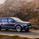 A photo of a purple Bentley Bentayga SUV extended wheelbase driving on a highway.